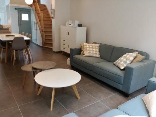 a living room with a couch and a table at The Front Door N12 in Ypres