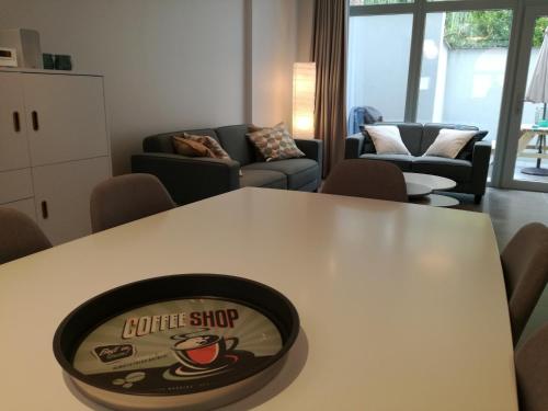 a table with a coffee shop sign on top of it at The Front Door N12 in Ypres