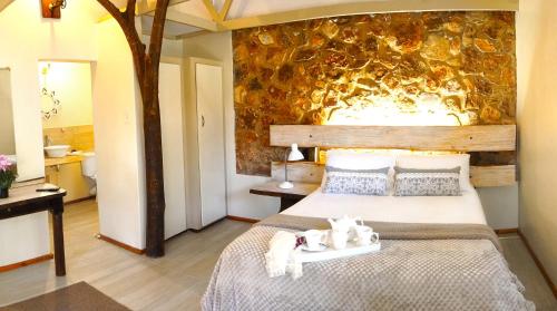una camera da letto con un letto con due gatti sdraiati sopra di Centurion Guest House and Lodge a Centurion