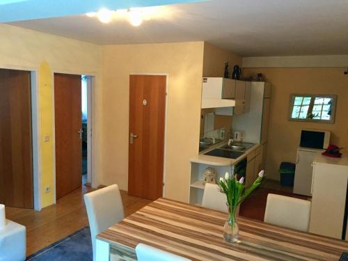 a kitchen and dining room with a table and chairs at Apartment "Herbert" Sonnleitn/Nassfeld in Sonnenalpe Nassfeld