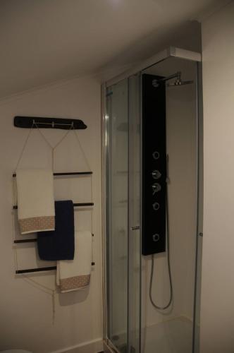 a bathroom with a shower and some towels at Casa BuonVento in Horta