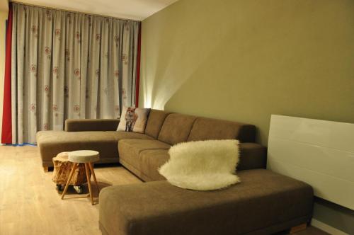 a living room with a couch and a chair at Haus Nohra in Sankt Michael im Lungau