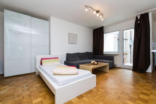 a living room with a bed and a couch at Altstadt Düsseldorf 1 in Düsseldorf