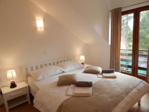a bedroom with a bed with two towels on it at Apartments Oltari in Sveti Juraj