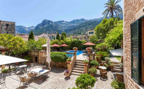 a patio with a pool and tables and chairs at The Salvia - Adults Only in Sóller
