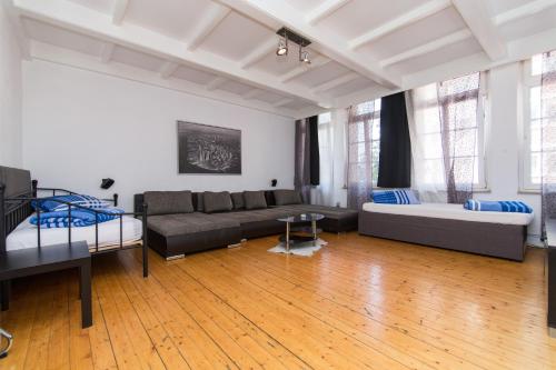 una sala de estar con un sofá y una cama en Altstadt Bolker Original, en Düsseldorf