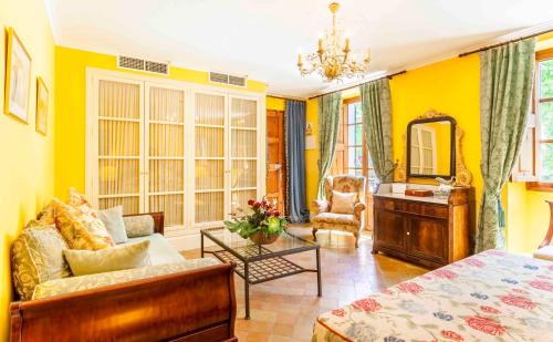 a living room with a bed and a mirror at The Salvia - Adults Only in Sóller