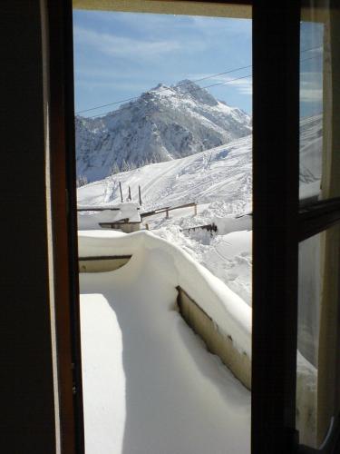 a view of a snow covered mountain from a window at Apartment "Gabi" Sonnleitn/Nassfeld in Sonnenalpe Nassfeld