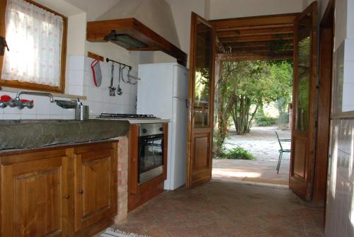 a kitchen with a stove and an open door at Agriturismo San Vettore in Gambassi Terme