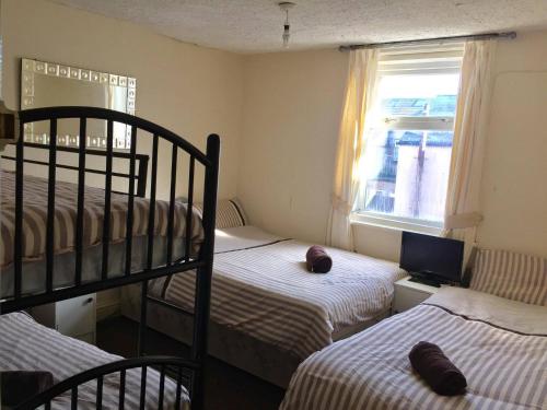 a bedroom with two bunk beds and a window at The Galloway in Blackpool