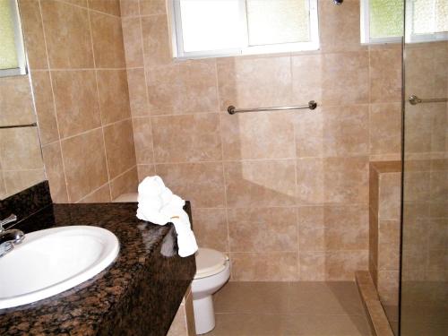a bathroom with a sink and a toilet and a shower at Hotel LunaSol in Playa del Carmen