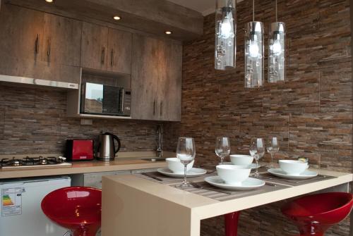a kitchen with a table with wine glasses on it at Amg Apartments in Santiago