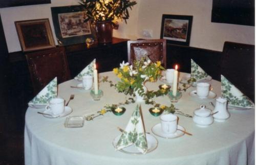 a table with christmas decorations and candles on it at Hotel Garni Graf von Oberg in Lahstedt