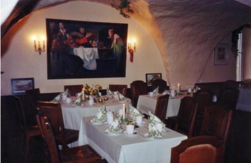 a dining room with white tables and chairs at Hotel Garni Graf von Oberg in Lahstedt