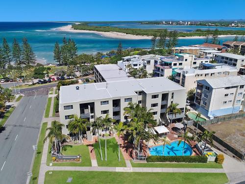 an aerial view of a building with a pool and the ocean at Joanne Apartments in Caloundra