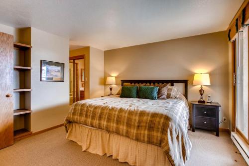 a bedroom with a large bed and two lamps at The Plaza Condominiums by Crested Butte Mountain Resort in Mount Crested Butte