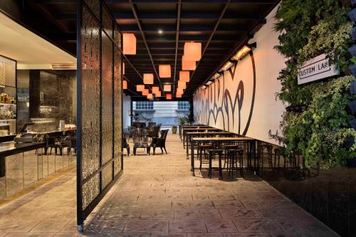 a dining room with tables and chairs in a restaurant at Mövenpick Hotel Auckland in Auckland