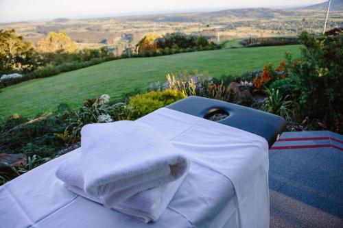 a table with towels on it with a view of a field at Mt Hay Retreat in Berry
