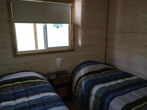 Cabañas en Malalcahuelloにあるベッド