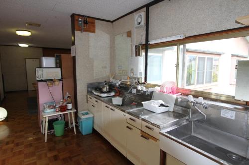 A kitchen or kitchenette at Towadako Backpackers