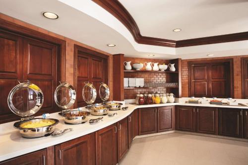a kitchen with wooden cabinets and bowls on the counters at Hyatt House Pleasant Hill in Pleasant Hill
