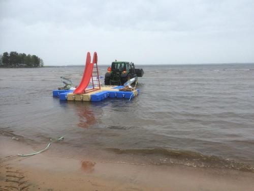 a boat in the water with a playground at Karlstad Swecamp Bomstadbaden in Karlstad