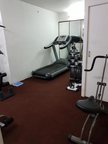 a room with a gym with a treadmill at Hotel Polo Towers Shillong in Shillong