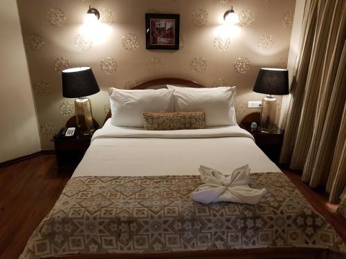 a bedroom with a bed with a flower on it at Hotel Polo Towers Shillong in Shillong
