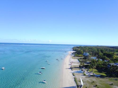 an aerial view of a beach with boats in the water at Paradise Beach Luxury Beachfront Apartment Pointe d'Esny in Pointe d'Esny