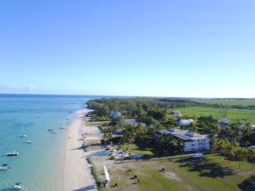 an aerial view of a beach with boats in the water at Paradise Beach Luxury Beachfront Apartment Pointe d'Esny in Pointe d'Esny
