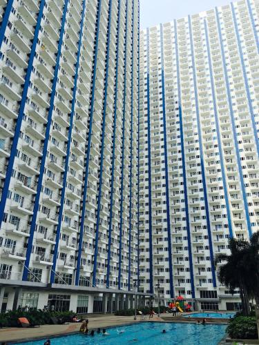 a large building with a swimming pool in front of it at SMDC Light Residences Condominium in Manila