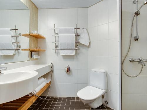 a white bathroom with a sink and a toilet at Original Sokos Hotel Kaarle Kokkola in Kokkola