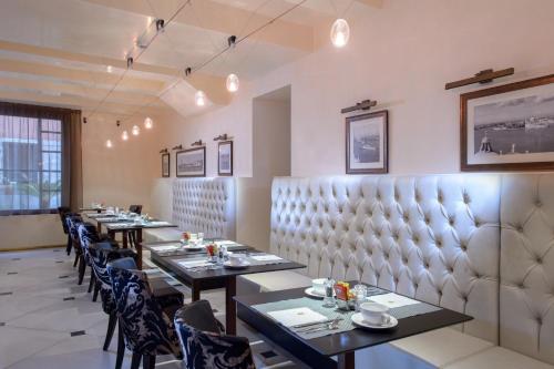 a dining room with long tables and chairs at Palazzo Veneziano - Venice Collection in Venice