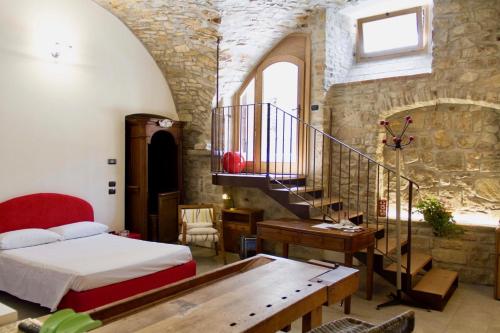 a bedroom with a bed and a staircase in a building at Casa Vacanza Gaia in Costa di Mezzate