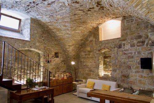 a living room with a stone wall at Casa Vacanza Gaia Happy in Costa di Mezzate