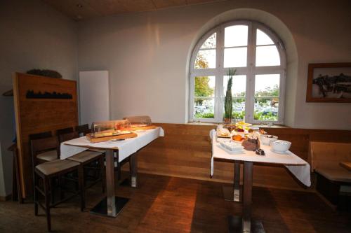 a dining room with two tables and a window at Volkspark in Bamberg
