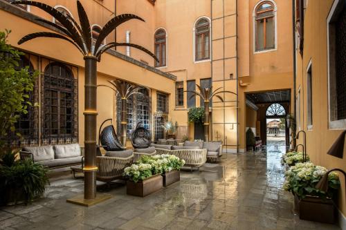 a lobby of a building with couches and plants at Palazzo Veneziano - Venice Collection in Venice
