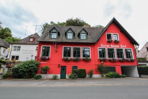 a red brick building with a red roof at Hotel-Restaurant Buger Hof in Bamberg