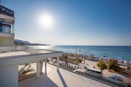 a view of a beach and the ocean from a building at Victoria Palace Cefalù in Cefalù