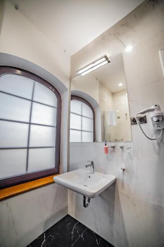 a bathroom with a sink and a window at Hotel Wodnik in Bydgoszcz