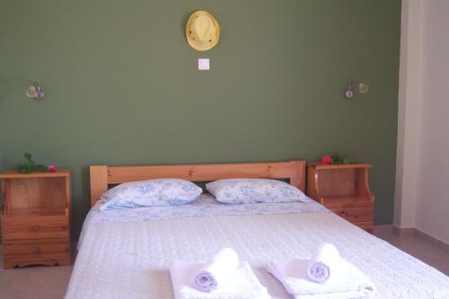 a bedroom with a bed with two towels on it at Melina Apartment in Loutrópolis Thermís