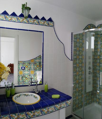 a bathroom with a sink and a mirror at Casa Rosetta in Praiano