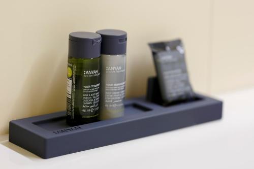 a shelf with two bottles of hair products on it at Penzión v Inom Svete in Žilina