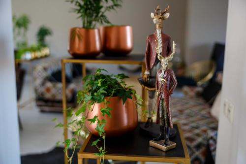 two deer statues on a table in a living room at Penzión v Inom Svete in Žilina