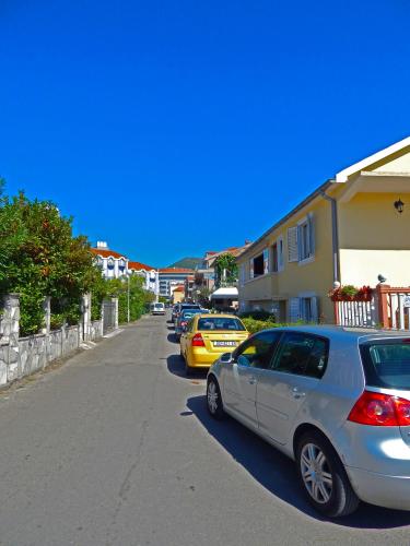 a row of cars parked on the side of a street at Apartmani Sindik in Tivat