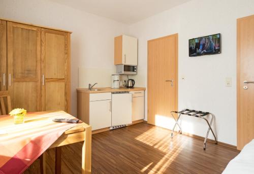 a small kitchen with a table in a room at Hotel Restaurant Schute in Emstek