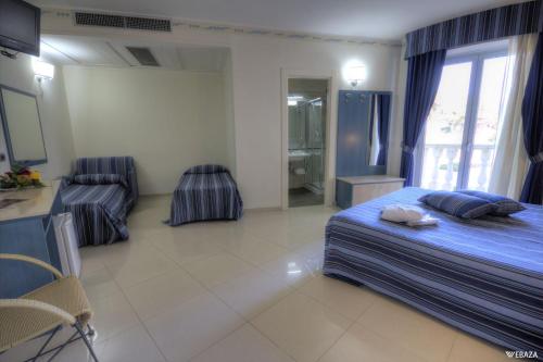 a hotel room with a bed and a bathroom at Grand Hotel Dei Cavalieri in Maruggio
