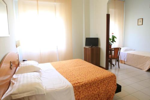 Postel nebo postele na pokoji v ubytování Hotel Calabresi