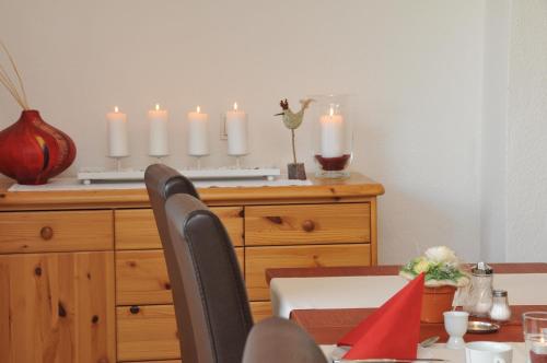 a dining room with a table with candles on a dresser at Pension Bella Vista in Bochum