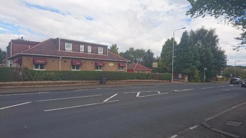 a house on the side of a road at Glenfern Guest House and a separate Cottage with its own private hot tub in Balloch